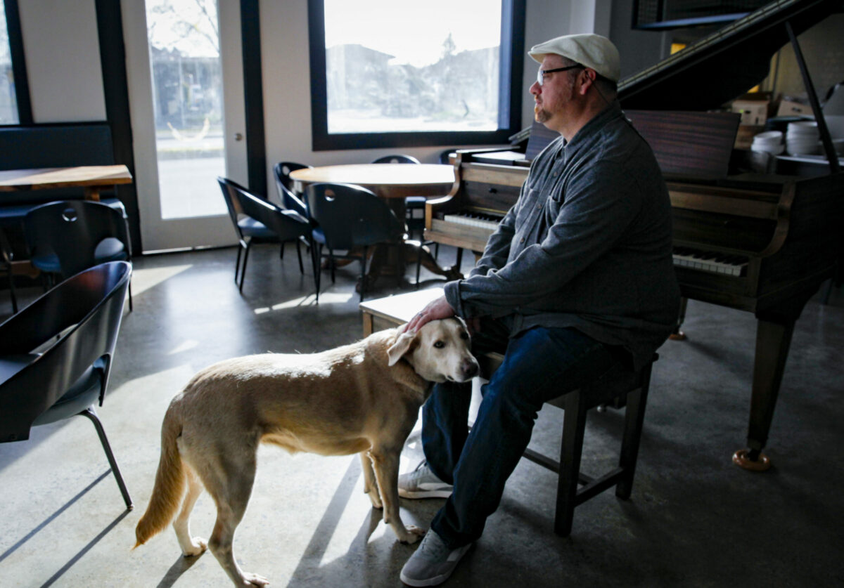 Chef Nick Ronan says the spirit and soul of his mother, who he named his restaurant after, is there with him at Brigitte Bistro. The baby grand piano is a reminder of one of his favorite places in France where he grew up. Photographed on Wednesday, March 13, 2024. (Crissy Pascual/Petaluma Argus-Courier)