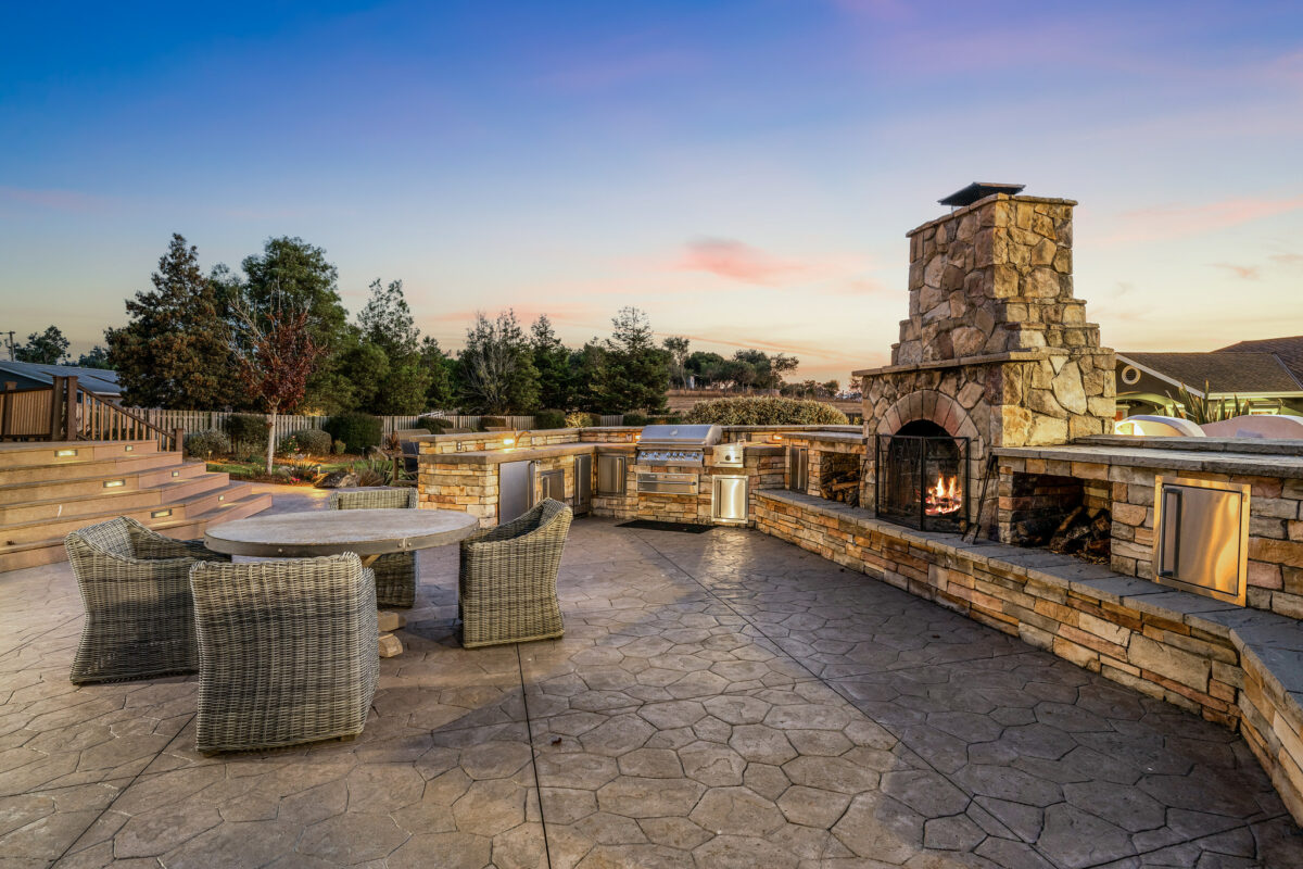 This outdoor kitchen includes a wood-burning pizza oven. (Open Homes)