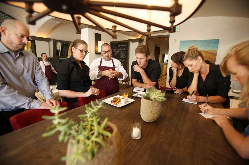 Chalkboard Restaurant head chef Shane McAnelly, fourth from the left, preps the restaurant's staff about the night's menu in Healdsburg on Tuesday, June 11, 2013. (Conner Jay/The Press Democrat)