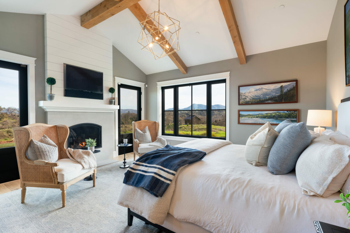 Traditional moldings, clean lines and a modern chandelier create transitional style in this main bedroom. (Ned Bonzi / Sotheby’s International Realty)