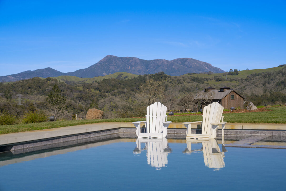 The pool has a shallow step on which Adirondack chairs sit. (Ned Bonzi / Sotheby’s International Realty)