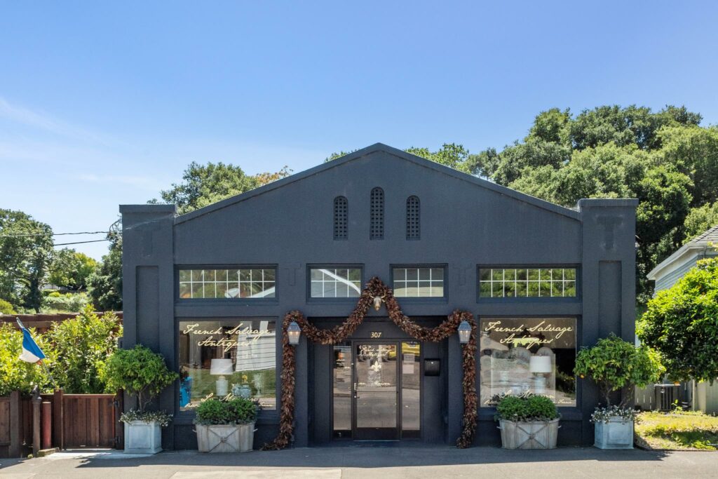 A mixed-use circa-1918 building with a retail space, adjacent apartment and a separate barn are currently listed for $3,850,000. The building is the current home of French Salvage Antiques resale boutique. (Open Homes Photography)