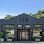 A mixed-use circa-1918 building with a retail space, adjacent apartment and a separate barn are currently listed for $3,850,000. The building is the current home of French Salvage Antiques resale boutique. (Open Homes Photography)