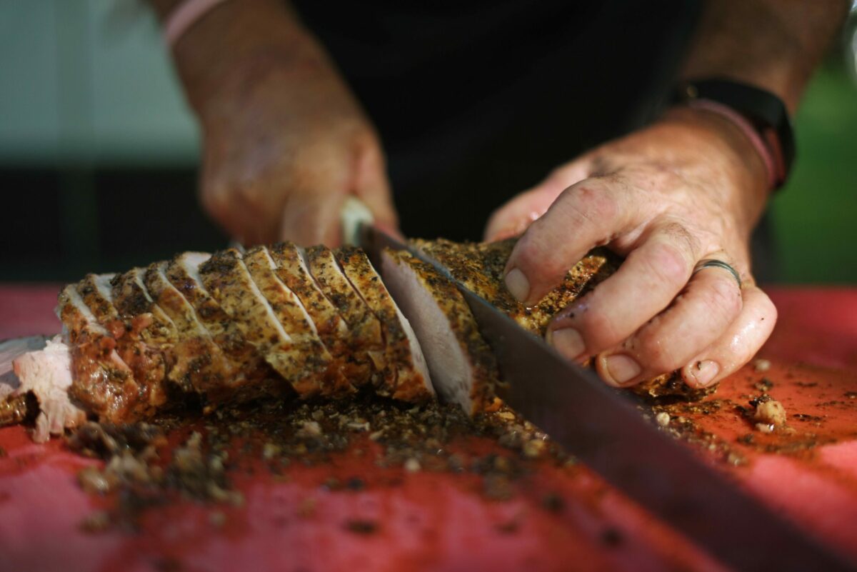 Mike Lombardi of Lombardi's Gourmet Deli and BBQ slicing up pork loin for guests during the 15th annual BBQ Fundraiser hosted by the Youth Ag & Leadership Foundation of Sonoma County at La Crema Estate at Saralee's Vineyard in Windsor on Saturday, Aug. 24, 2019. (Erik Castro/ for The Press Democrat)