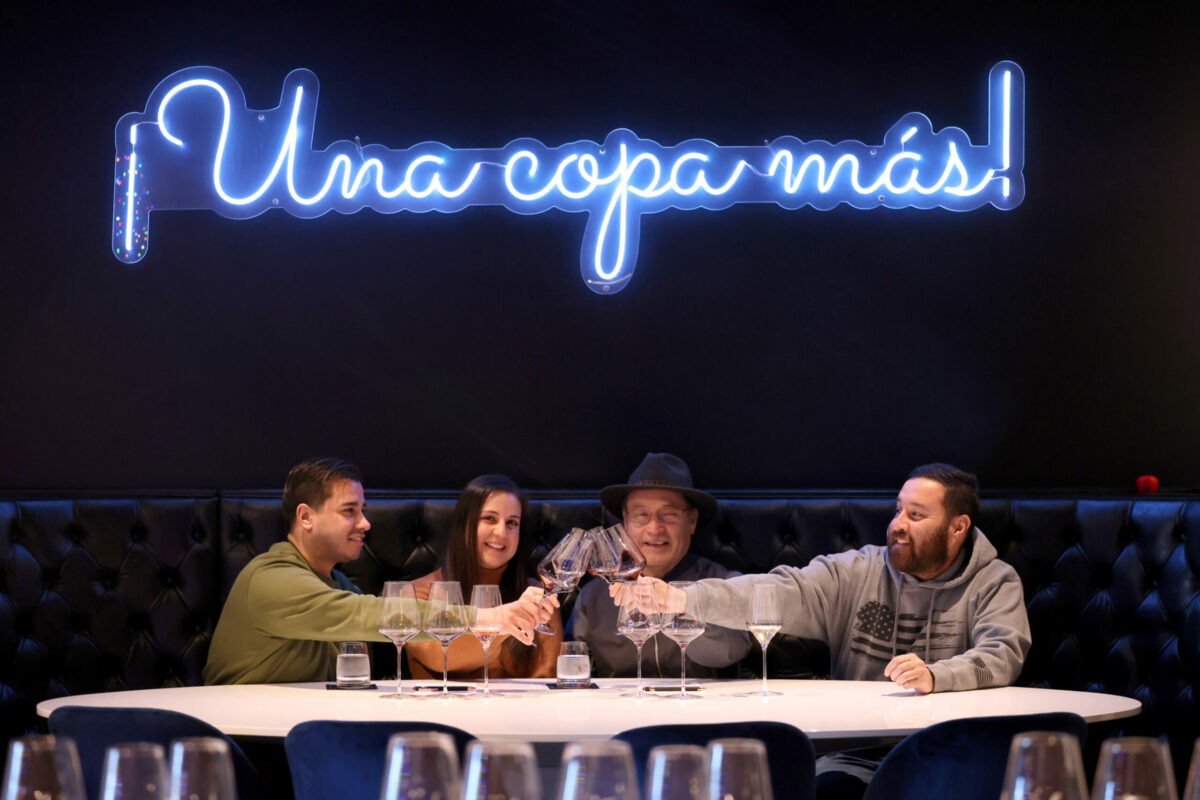 Roberto Corona Jr., center right, toasts with his daughter, Gaby Corona, his son-in-law, Alvaro Camacho, left, and his son, Roberto, Corona III, right, at MaCo Vineyards tasting room in Napa, Thursday, Jan. 4, 2024. (Beth Schlanker / The Press Democrat)