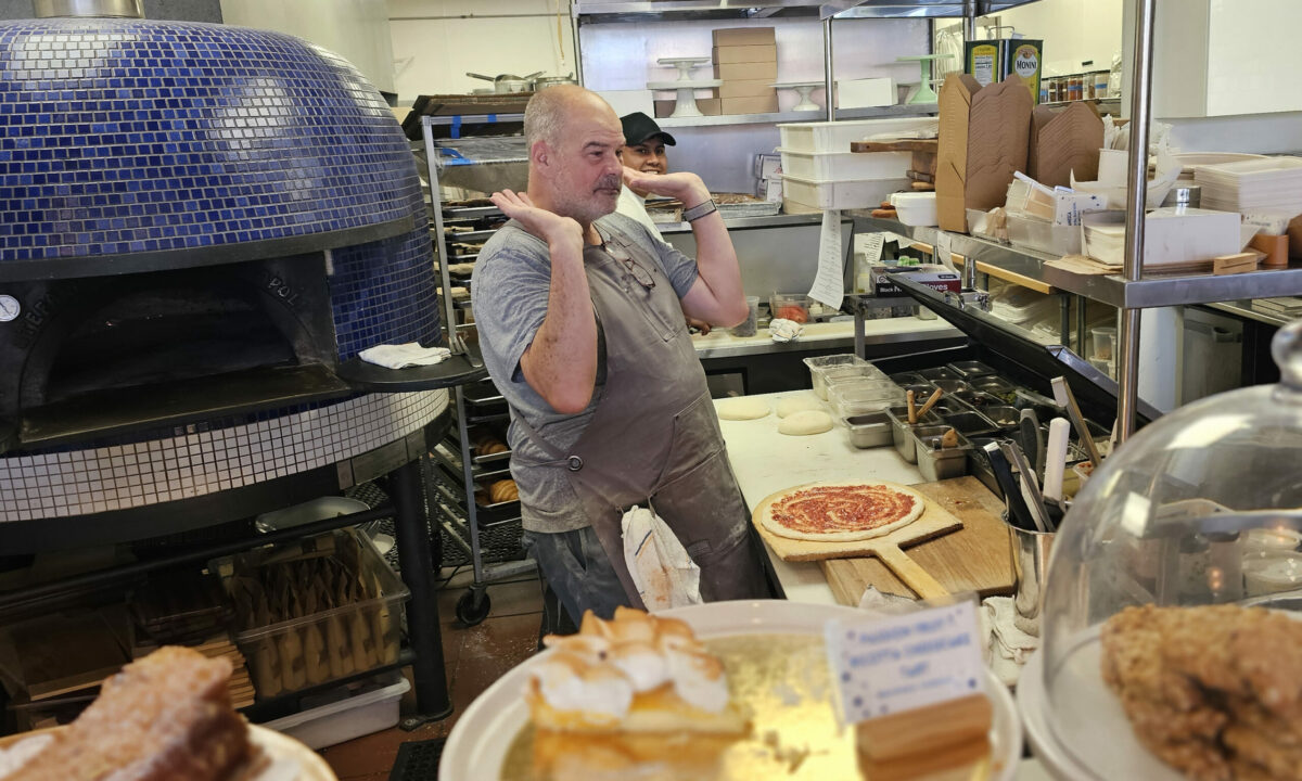 Chef Christian Caiazzo raises the roof as he finally fires up his Italian wood-fired oven at Stellina Pronto pizzeria and bakery in Petaluma. (Heather Irwin/The Press Democrat)
