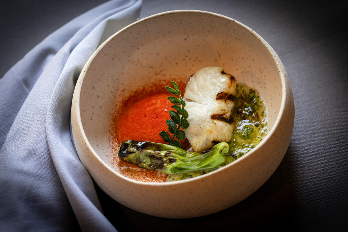 Black Cod left overnight in lemon salt then grilled with blistered shosito, sauce ravigote and kinome leaf from chef Craig Wilmer at the Farmhouse restaurant on River Road in Foresville, Friday, Aug. 18, 2023. (John Burgess / The Press Democrat)