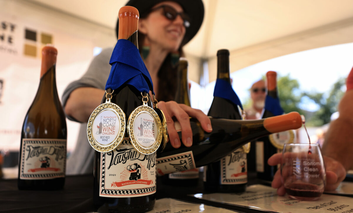 Sara Vaughn of Vaughn Duffy Wines pours their 2021 Pinot Noir Bacigalupi Vineyards during the North Coast Wine and Food Festival at the Luther Burbank Center for the Arts in Santa Rosa, Saturday, June 17, 2023. (Kent Porter / The Press Democrat)