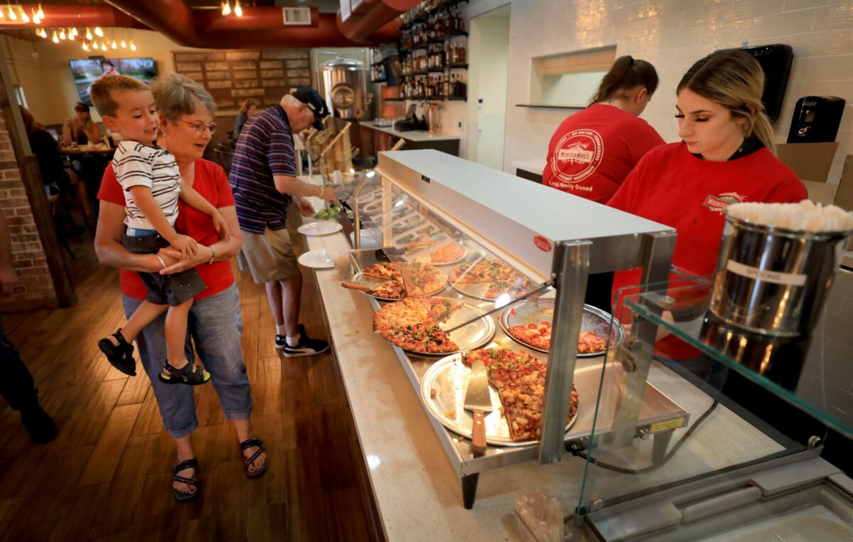 Diantha Okrepkie and her grandson Tillman Okrepkie, 3, look over the pizza buffet at the newly reopened Mountain Mike's Pizza on Friday, July 5, 2019. The 2017 Tubbs fire destroyed their original location. (Kent Porter / The Press Democrat)