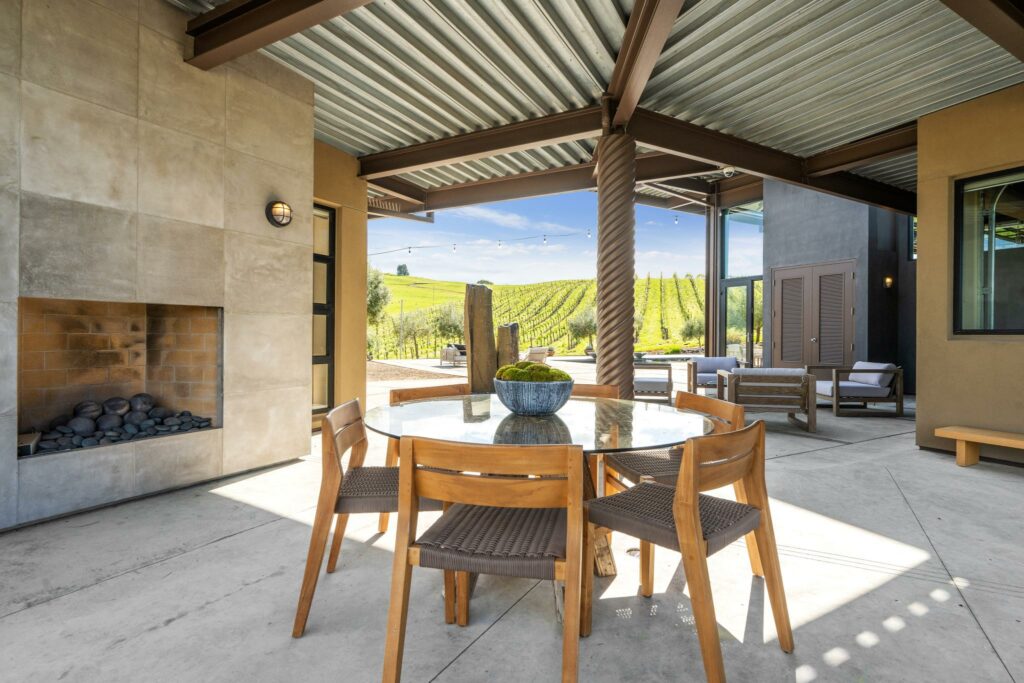 Outdoor fireplace and dining area. (Open Homes Photography / Sotheby’s International Realty)