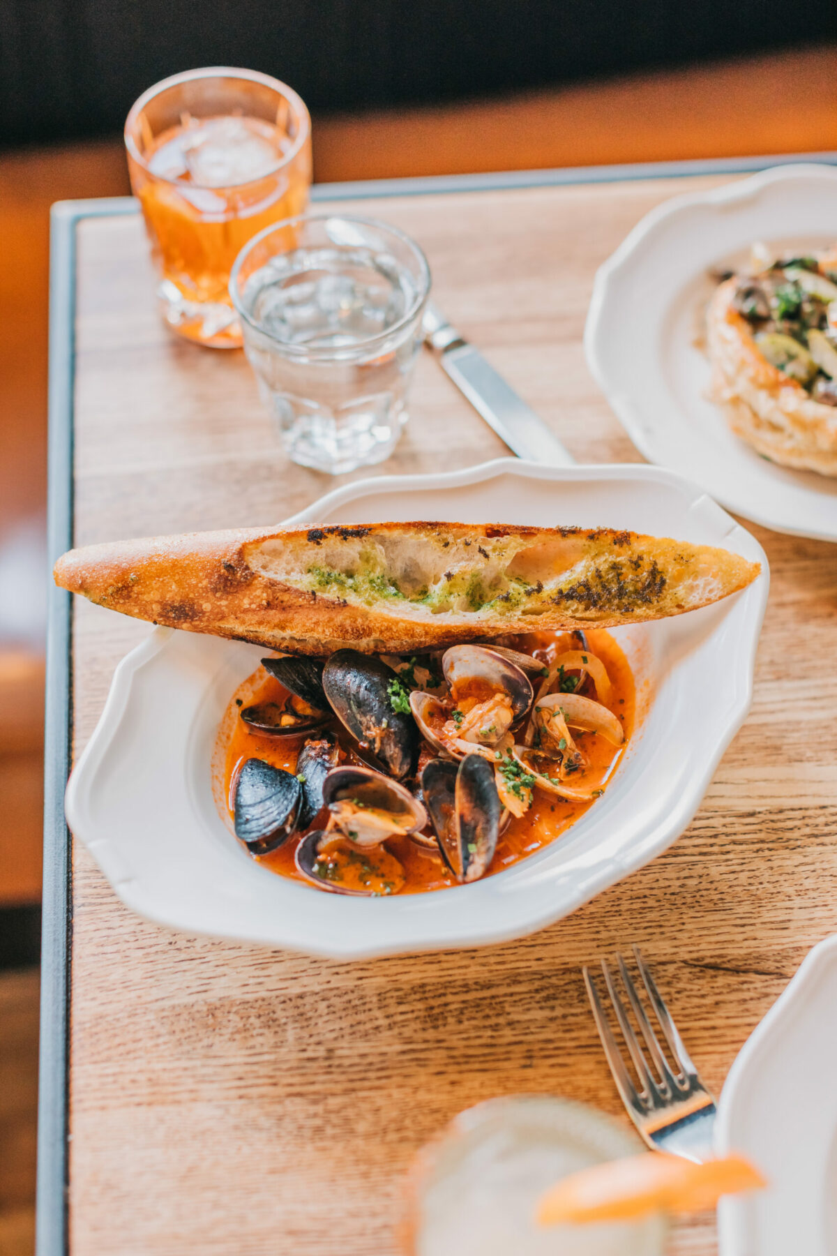 Mussels and Manila clams in a tomato-fennel broth with a side of charred bread at Due West Tavern, located next to Olema House in Olema, near Point Reyes National Seashore. (Roxanne McClure Photography)