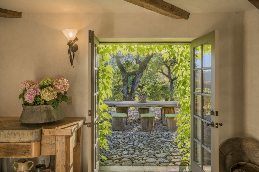 The terrace and many of the home's walls are made of hand laid stones Other walls are made from limestone plaster. (CS Photography / Sotheby’s International Realty)