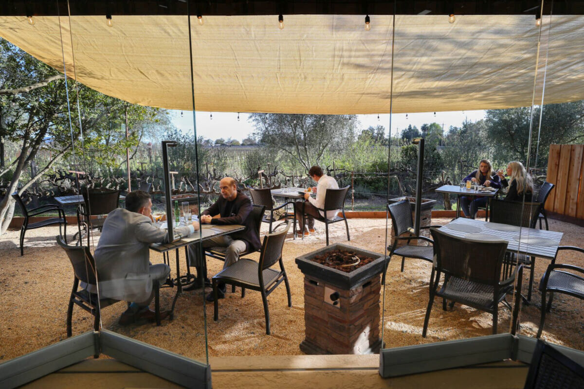 Diners occupy the new patio area installed at John Ash & Co. restaurant in Santa Rosa on Tuesday, March 23, 2021. The patio occupies an area that was formerly an herb garden, and was built to accommodate outdoor dining due to the coronavirus pandemic dining restrictions. (Christopher Chung/ The Press Democrat)