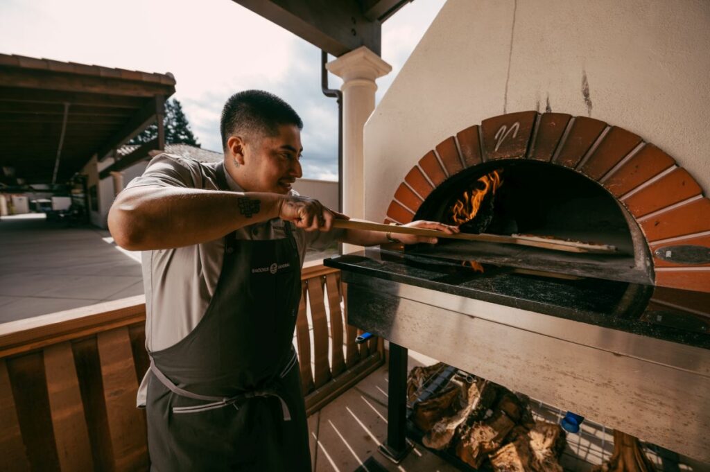 Chef Tomas Guzman at the pizza oven at Bacchus Landing in Healdsburg