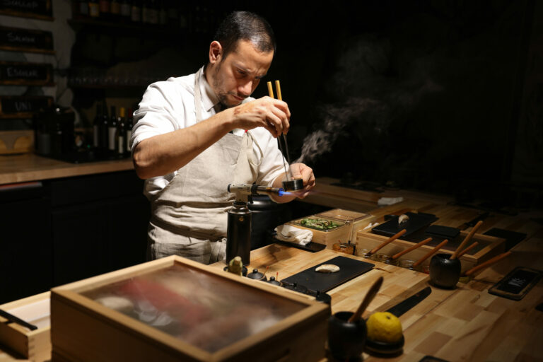 Chef Willer Larreal prepares a topping for his escolar sushi at Sushi by Scratch in Healdsburg, Friday, Jan. 19, 2024. (Christopher Chung / The Press Democrat)