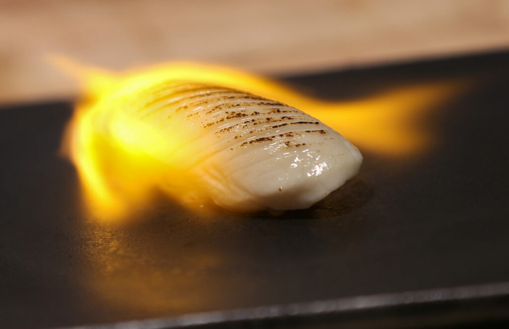 Chef Willer Larreal uses a torch while preparing escolar at Sushi by Scratch in Healdsburg, Friday, Jan. 19, 2024. (Christopher Chung / The Press Democrat)