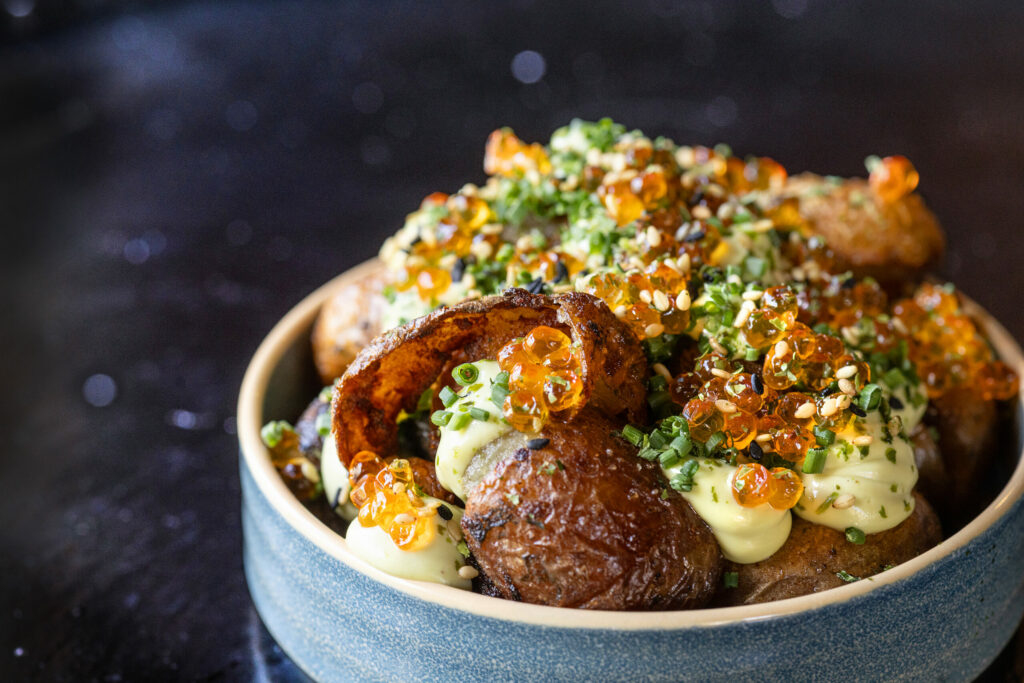 Papas with chili salt, avocado crema, chives, sesame seeds and smoked trout roe from Arandas Friday, June 28, 2024 in Healdsburg. (Photo by John Burgess/The Press Democrat)