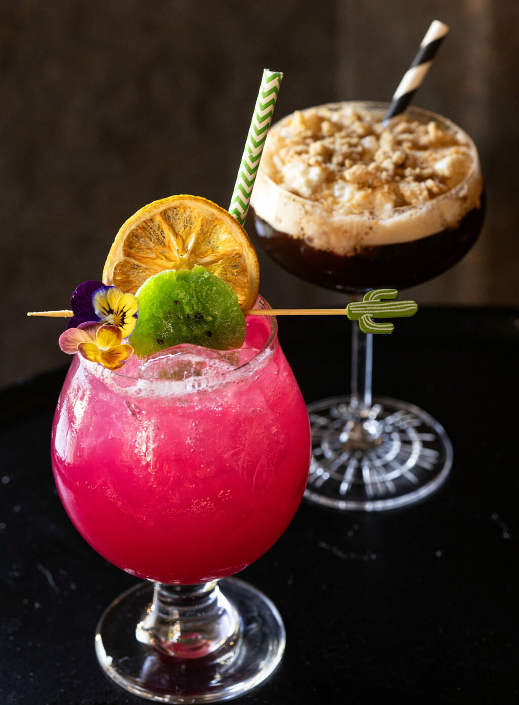 La Pera Perfecta, front, an alcohol-free cocktail with prickly pear, lemon juice, agave, kiwi and egg white. Rear, a Churro-tini with brown butter washed rum, borghetti, espresso, cinnamon simple sugar topped with Drambuie cinnamon whipped cream from Arandas Friday, June 28, 2024 in Healdsburg. (Photo by John Burgess/The Press Democrat)