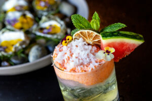 The Double Trouble Clarified Margarita with El Mexicano tequila blanco, coconut washed rum, Cointreau, lime, watermelon juice, Coco Lopez and rosé-mint-watermelon water with a plate of oysters from Arandas Friday, June 28, 2024 in Healdsburg. (Photo by John Burgess/The Press Democrat)