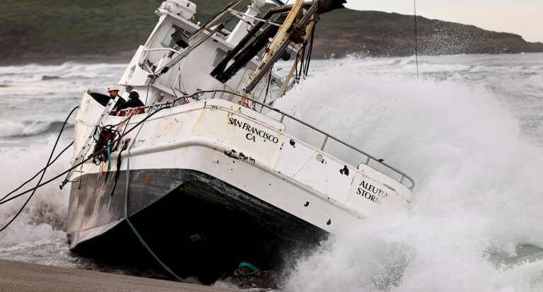 Personnel from a salvage crew wait to offload equipment from the Aleutian Storm, Friday, Feb. 16, 2024. After offloading a pump and fuel hoses, the seas became too rough to continue working on the beached vessel at south Salmon Creek State Beach, north of Bodega Bay. (Kent Porter / The Press Democrat)