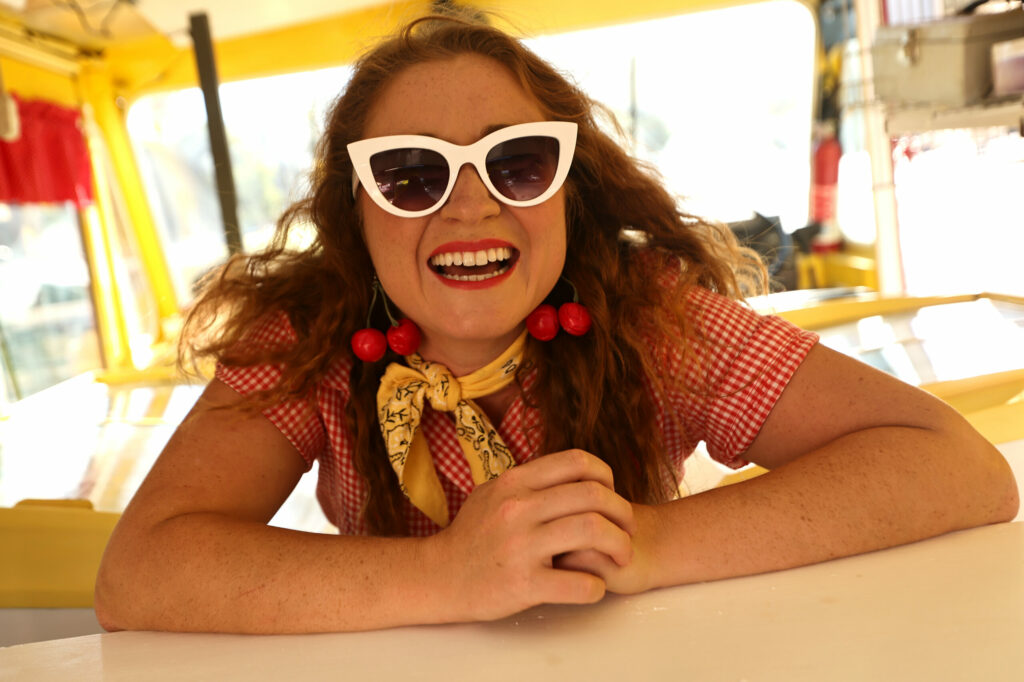 Anamaria Morales, the College Confectionista, takes 30 seconds to sit for a portrait, Tuesday, July 30, 2024, during a very brief lull in business after she opened a pop-up mobile cheesecake truck in downtown Guerneville. (Kent Porter / The Press Democrat) 2024