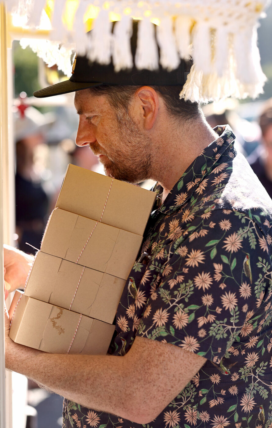 Kris Davis of Berkeley pays for four boxes of cheesecakes made by Anamaria Morales, the College Confectionista, during her pop-up mobile cheesecake truck in downtown Guerneville, Tuesday, July 30, 2024. (Kent Porter / The Press Democrat) 2024