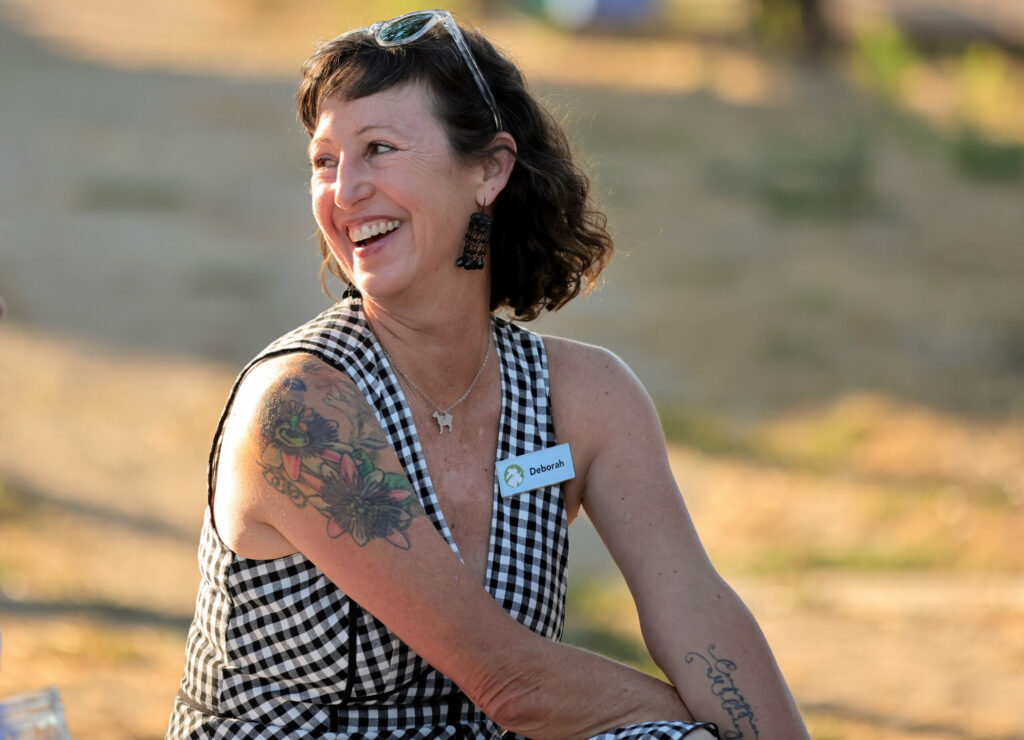 Deborah Blum, founder and executive director of Goatlandia, laughs during Goatchella, a gala fundraiser at Goatlandia animal sanctuary in Sebastopol, Sunday, Aug. 27, 2023. (Darryl Bush / For The Press Democrat)