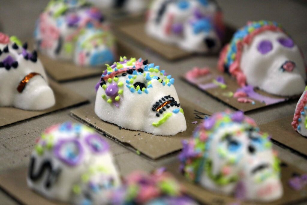 Sugar skulls decorated with icing sit and dry during the Dia de los Muertos family day at the Sonoma County History Museum in Santa Rosa on Sunday, October 21, 2018. (Beth Schlanker / The Press Democrat)