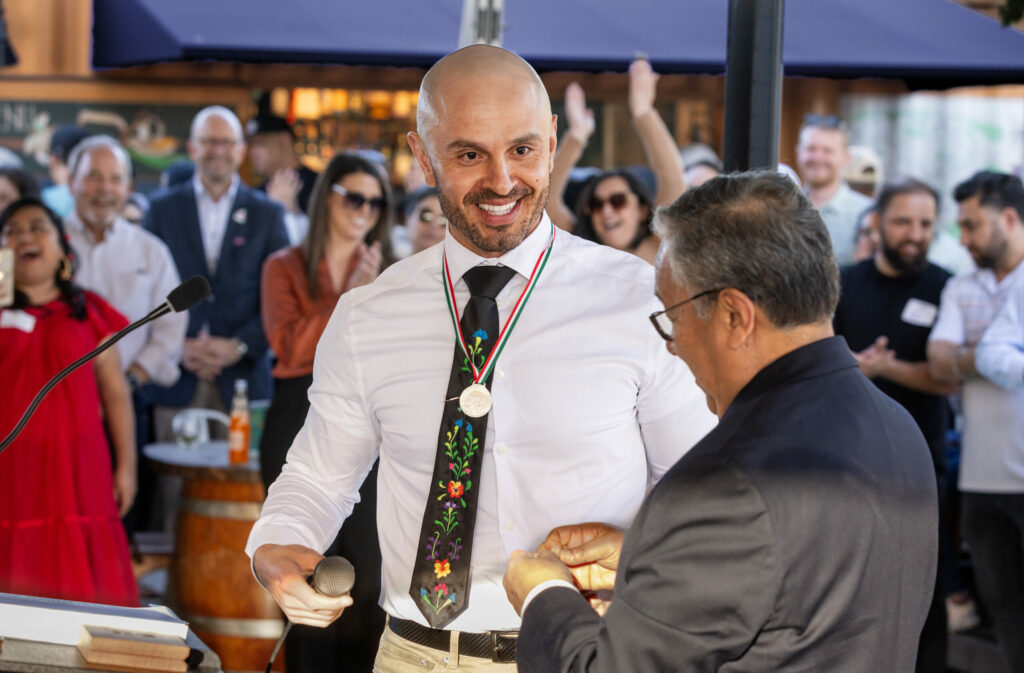 Herman G. Hernandez, executive director of Los Cien, receives the Ohlti Award from the Mexican Consul Vicente Sánchez Ventura, right, Thursday, May 2, 2024 at the Mitote Park in Santa Rosa. (John Burgess / The Press Democrat)