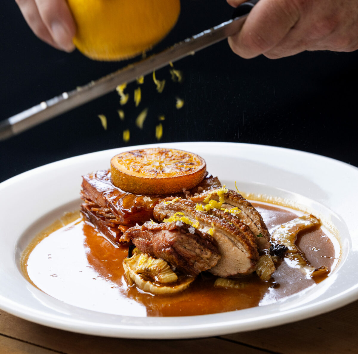 Duck a L’Orange with duck fat potato mille feuille, fried slice of orange, roasted fennel with an orange-duck sauce from Brigitte Bistro Sunday, July 6, 2025 in Petaluma. (John Burgess / The Press Democrat)