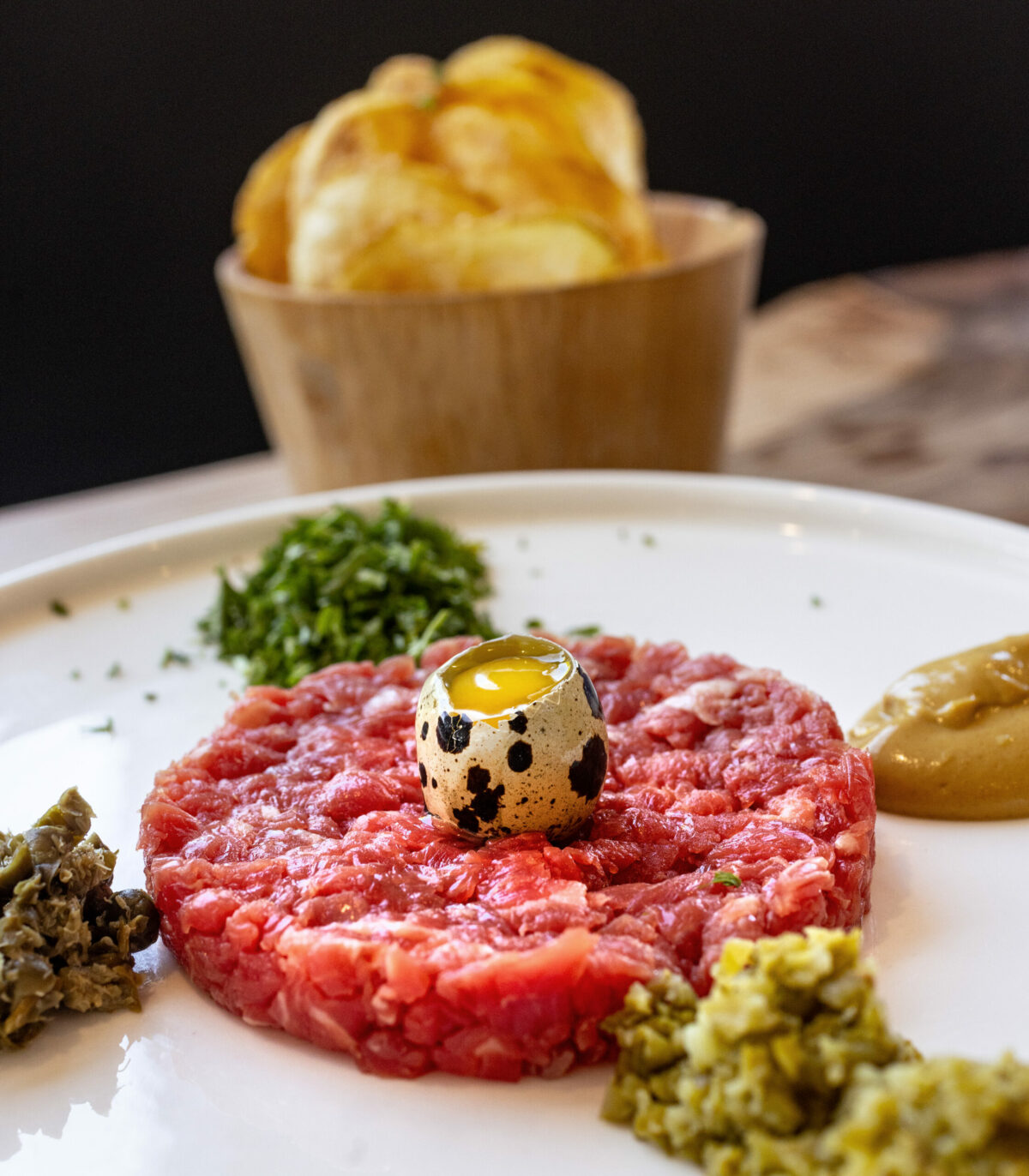 Traditional Table Side Steak Tartare with knife hand cut flank steak, quail egg, cornichons, capers, olive oil, dijon mustard and pommes gaufrette from Brigitte Bistro Sunday, July 6, 2025 in Petaluma. (John Burgess / The Press Democrat)