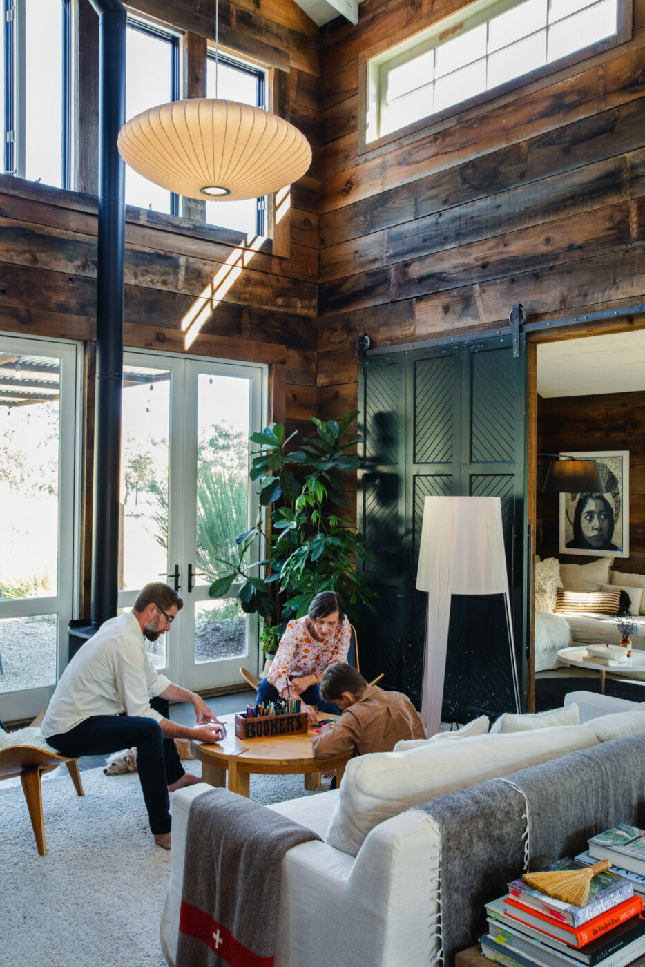 Double-height ceilings in the main living space. Downstairs is one large room with separate spaces carved out for living, dining, lounging and cooking. (Eileen Roche/Sonoma Magazine)