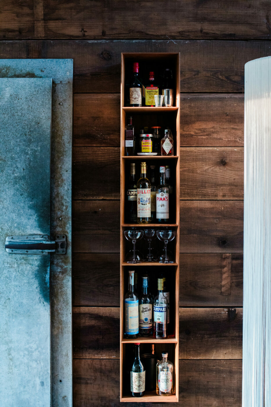 Creative repurposing at play in the interior of Scot Bilbro and Lisa Steinkamp's Healdsburg home. Reclaimed redwood siding and a repurposed metal meat-locker door. (Eileen Roche/Sonoma Magazine)