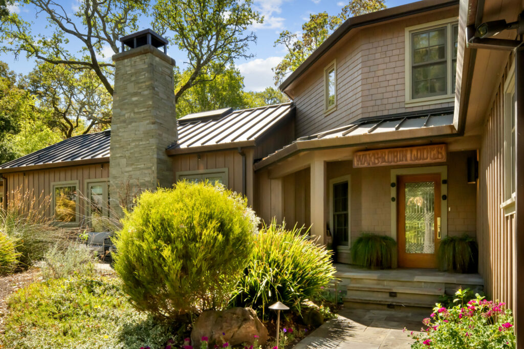 Front of the modern Wake Robin Lodge. The beveled glass in the door was sourced from the original lodge. (Sea Timber Media)