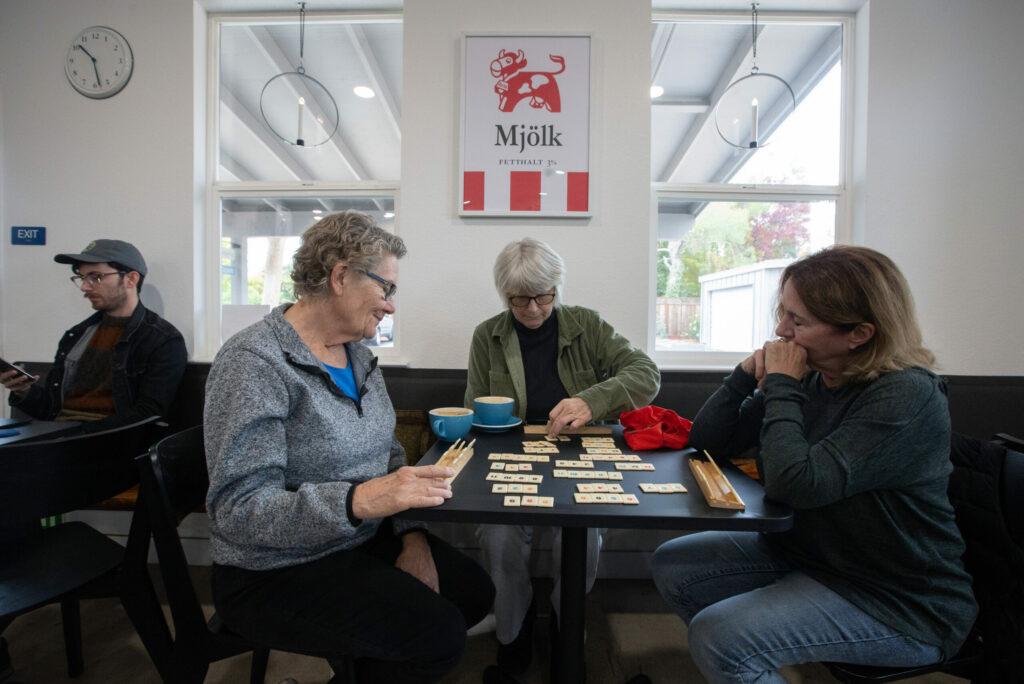 From left, Janel Osowski, Cynthia Carr and Sandi Everett enjoy playing Rummikub at Småstad Coffee Roasters on Broadway. They used to play the game at The Barking Dog, in Boyes Hot Springs, the previous incarnation of the cafe, and have followed the convivial atmosphere and custom-made coffee drinks to its new location. Photo taken on Wednesday, Nov. 13, 2024. (Robbi Pengelly / Sonoma Index-Tribune)
