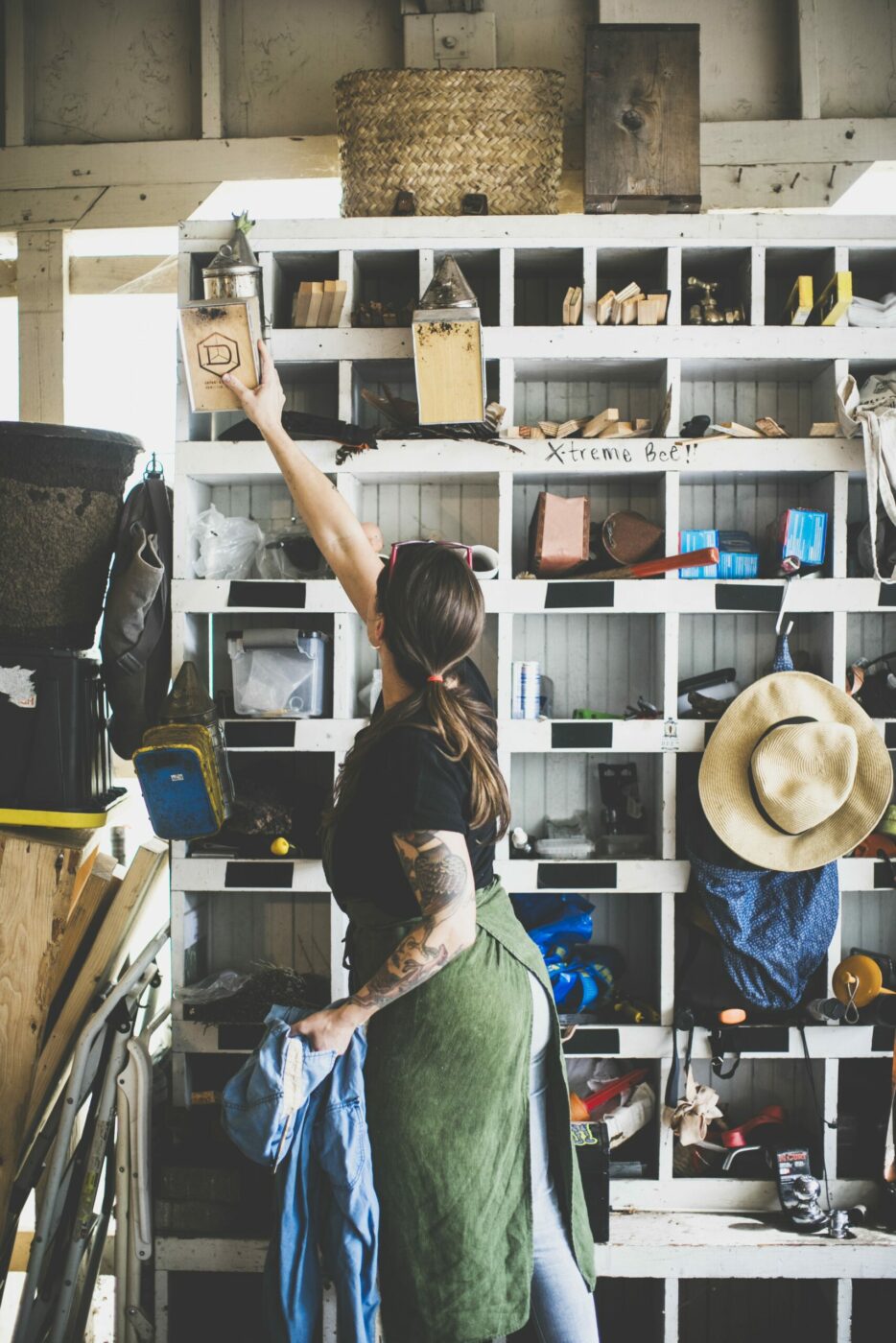 Candice Koseba reaches for a smoker, a tool used to keep bees calm during work inside the hive. (Bryan Meltz/Sonoma Magazine)