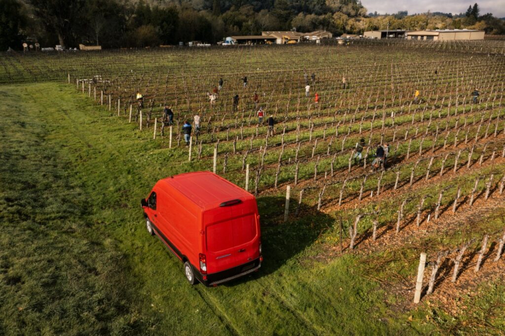 A Ford E-Transit electric van is parked next to vine rows Tuesday, Jan. 25, 2022, at Dutton Ranch in Sebastopol during a Ford Motor Company demonstration of electric professional vehicles being tested with certain Sonoma County Winegrowers members. (Courtesy of Ford Motor Company)