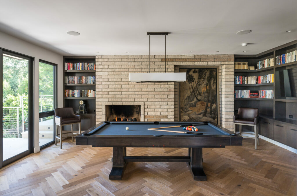 Billiards room with fireplace that has an inlet for artwork. (SeaTimber Media / Sotheby’s International Realty)