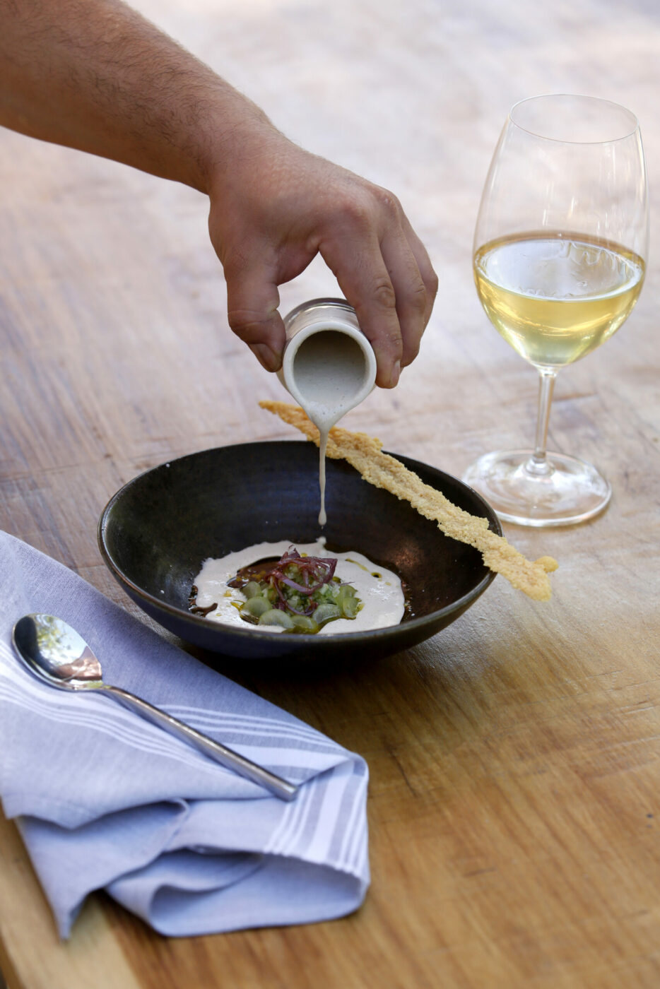 A white gazpacho made with walnuts, cucumbers, grapes, onions, garlic and olive oil by Executive Chef Oscar Bendeck at Kivelstadt Cellars Wine Garden and Eatery in Sonoma, Calif., on Thursday, July 8, 2021. (Beth Schlanker/The Press Democrat)