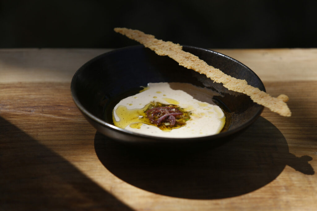 A white gazpacho made with walnuts, cucumbers, grapes, onions, garlic and olive oil by Executive Chef Oscar Bendeck at Kivelstadt Cellars Wine Garden and Eatery in Sonoma, Calif., on Thursday, July 8, 2021. (Beth Schlanker/The Press Democrat)