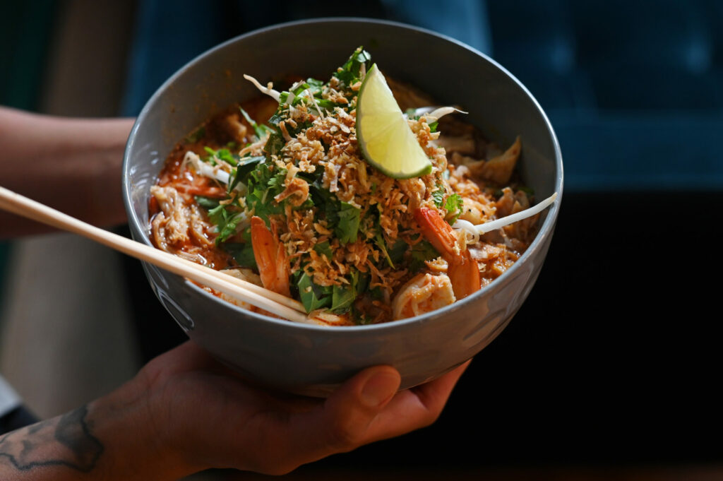 Laksa, a spicy Malaysian noodle soup, with shrimp and chicken prepared by Chef Jessy Manuel at Songbird Parlour in Glen Ellen on Tuesday, June 18, 2024. (Erik Castro / For The Press Democrat)