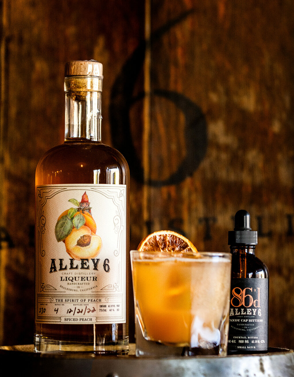 The By the Bushel cocktail features Alley 6 Craft Distillery's Spiced Peach liqueur and Candy Cap Bitters with honey, fresh apple and lemon juice with a dehydrated orange slice Tuesday, October 8, 2024 in Healdsburg. (John Burgess / The Press Democrat)