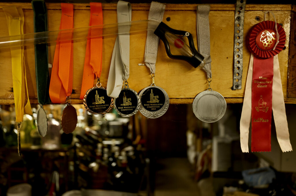 Awards in the basement of Doug Ghiselin's wine cellar Saturday, July 6, 2024, during a work party with the Sonoma Winemakers Club. (Kent Porter/The Press Democrat) 