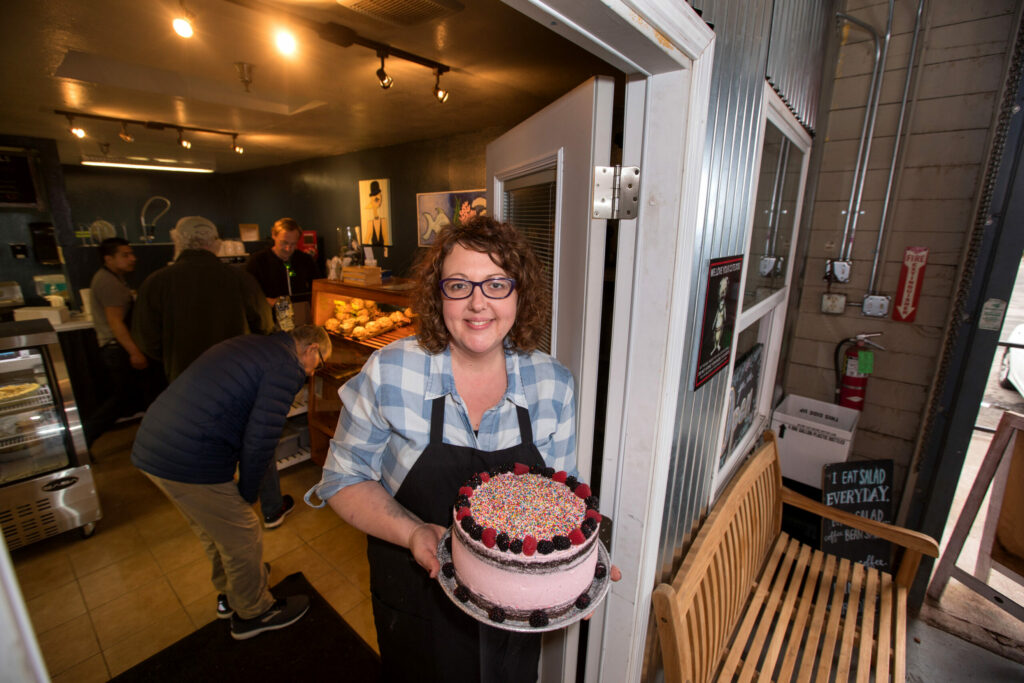Dawn Zaft, owner of the bakery, "Criminal Baking Company" holds a cake at her bakery that she just moved into, one of several businesses inside the old winery building on Donahue St. in Santa Rosa, on Friday, January 18, 2019. (Darryl Bush / For The Press Democrat)