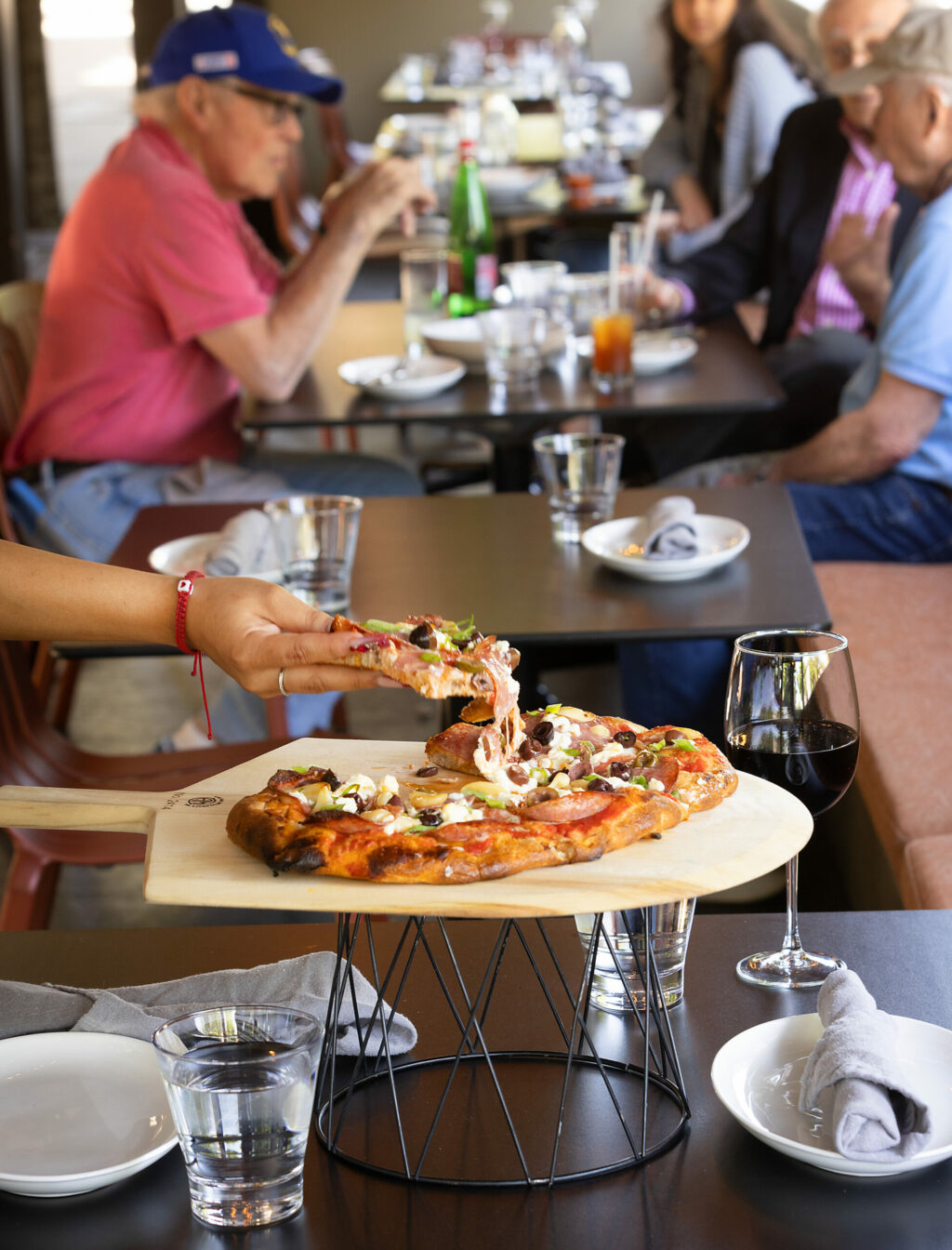 Finocchiona pizza with fennel salami, Greek olives, feta, green onion and garlic confit from Pizzando on the square in Healdsburg, Friday, June 2, 2023. (John Burgess / The Press Democrat)
