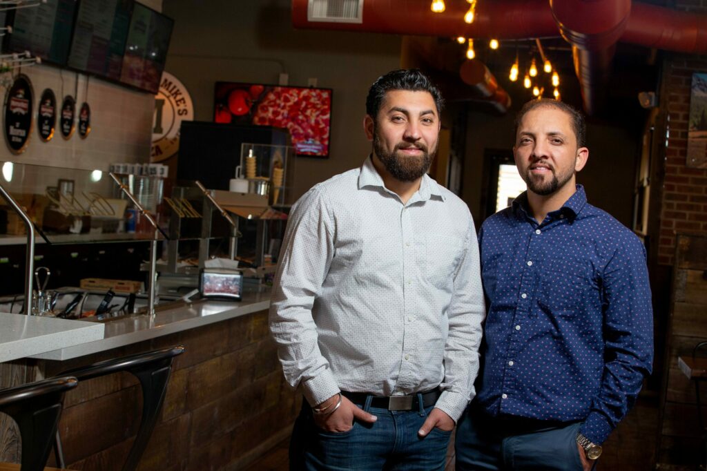 Chandi Hospitality Group senior vice president/COO Joti Chandi, left, and founder/president Sonu Chandi pose for a portrait at the rebuilt Mountain Mike's Pizza location on Cleveland Avenue in Santa Rosa on Wednesday, Nov. 20, 2019. (Alvin Jornada / The Press Democrat)