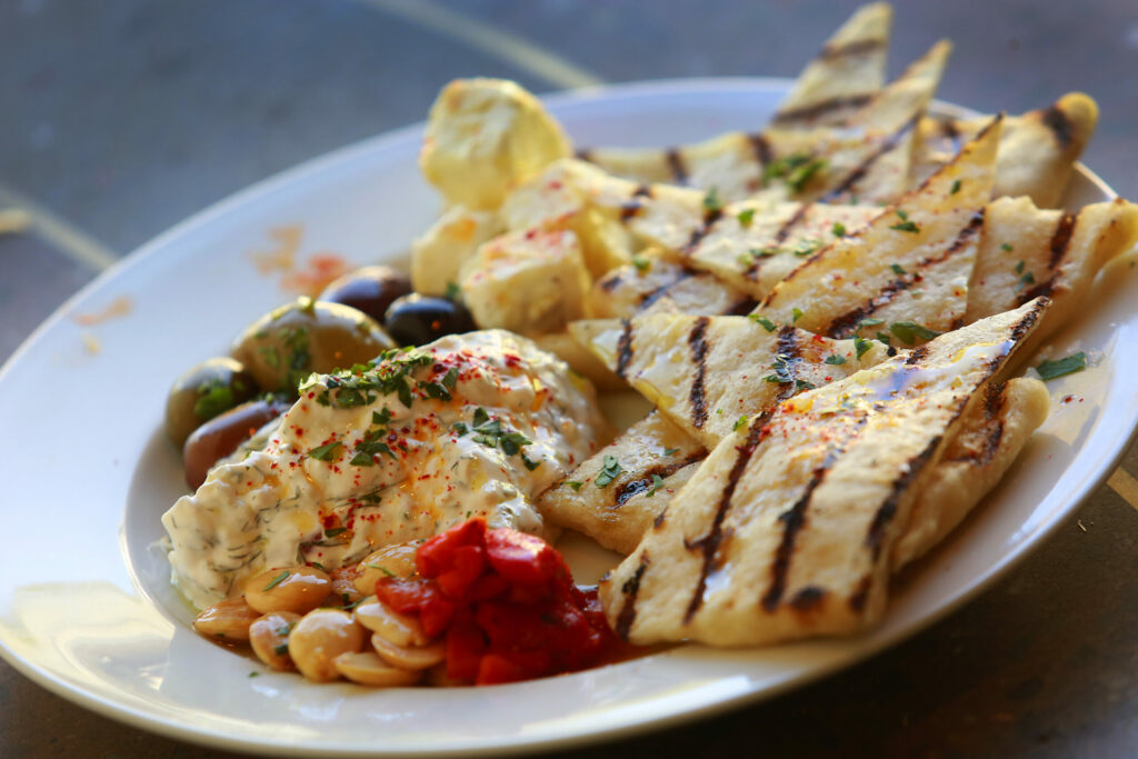 Grilled pita with eggplant spread,Tzatziki, roasted red pepper, French feta and olives at Hazel in Occidental. (John Burgess / The Press Democrat)