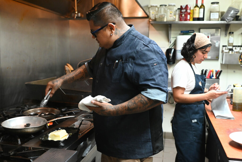 Chef Jorge Flores, left, with sous chef Isabella Cafferata at Costeaux French Bakery preparing classic French bistro menu items for the patio at their cafe in Healdsburg on Wednesday, July 31, 2024. (Erik Castro / For The Press Democrat)