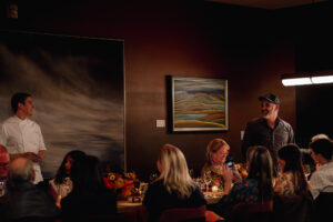 A fall 2024 event at The Restaurant at North Block in Yountville announcing the debut of its new Valley to the Coast tasting menu also featured artwork and wine from the Harris Gallery. The gallery's pieces still adorn walls throughout the restaurant. (Verena Dohmen Photography)