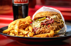 The “Mother-Clucker” sandwich with twice fried chicken, slaw, pickled jalepeño, bang bang dip on a toasted brioche bun from Shokakko, an Asian street food truck on their regular Thursday night visit Jan. 23, 2025 at Old Caz Beer in Rohnert Park. (John Burgess / The Press Democrat)